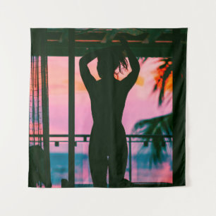 Woman in black tank top and pants standing on blac tapestry