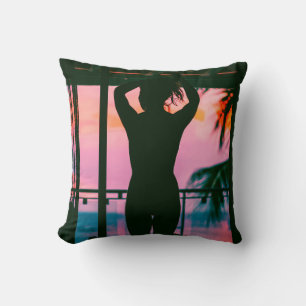 WOMAN IN BLACK TANK TOP AND PANTS STANDING ON BLAC THROW PILLOW