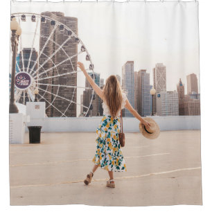 Woman in white and blue floral dress holding hat