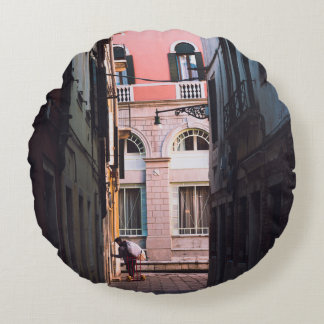 WOMAN IN WHITE SHIRT AND BLACK PANTS WALKING ON SI ROUND PILLOW