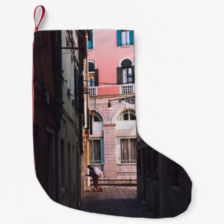 WOMAN IN WHITE SHIRT AND BLACK PANTS WALKING ON SI SMALL CHRISTMAS STOCKING