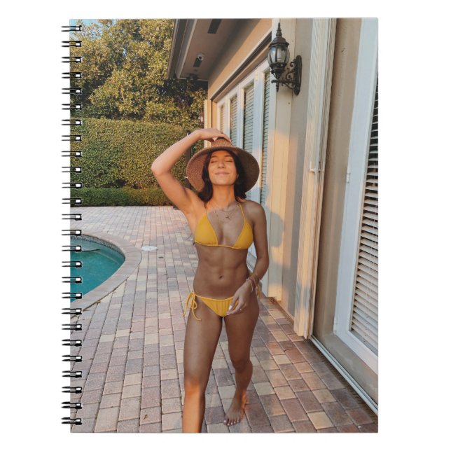 Woman in yellow bikini standing on brown brick flo notebook (Front)