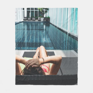 Woman laying on brown chaise lounge fleece blanket
