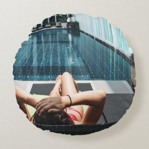 Woman laying on brown chaise lounge round pillow