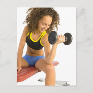 Woman lifting weights postcard