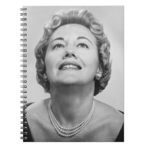 Woman Looking Up Notebook