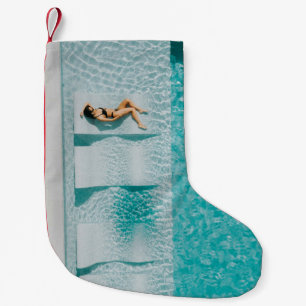 Woman lying on lounge small christmas stocking