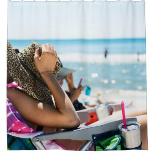 Woman lying on sun lounger covering her face with