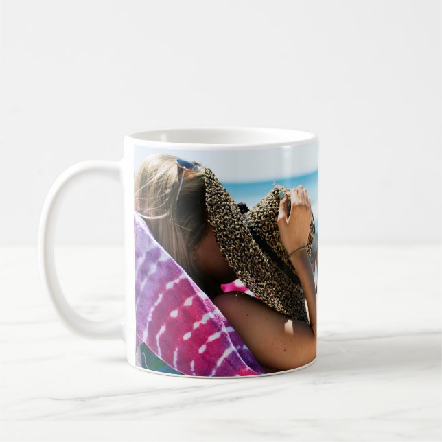 Woman lying on sun lounger covering her face with  coffee mug (Left)