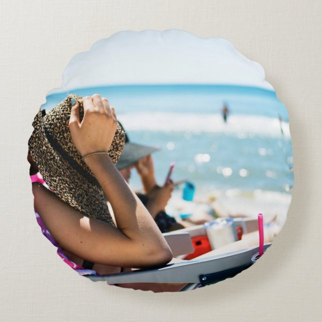 Woman lying on sun lounger covering her face with  round pillow (Front)