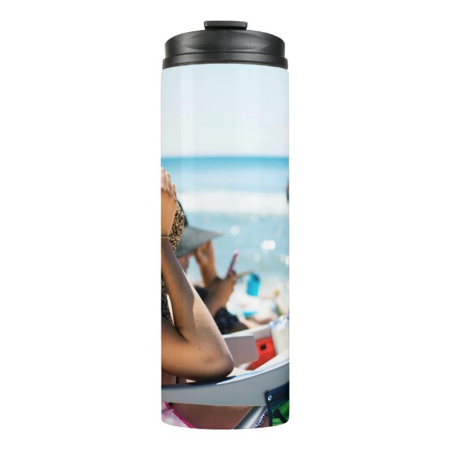 Woman lying on sun lounger covering her face with  thermal tumbler (Front)