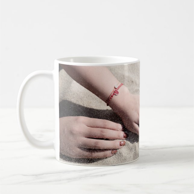 Woman lying on white sand coffee mug (Left)