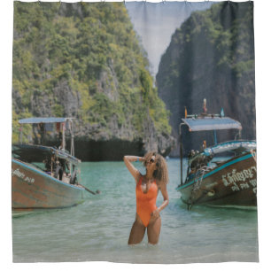 Woman on body of water between brown boats