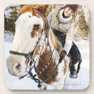 Woman on horse outdoors during winter coaster