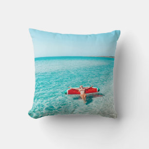 Woman on lilo in the sea water. Girl relaxing on i Throw Pillow