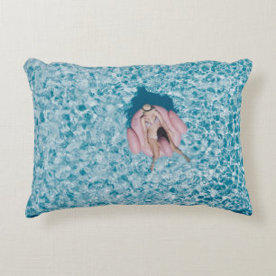 Woman on pink buoy surrounded by body of water in accent pillow