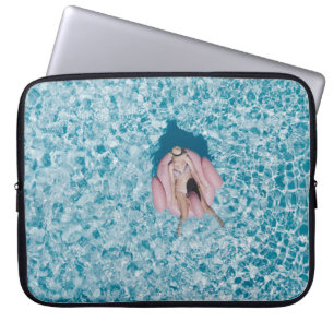 Woman on pink buoy surrounded by body of water in  laptop sleeve