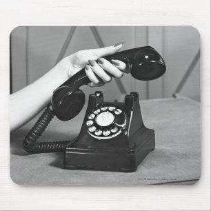 Woman picking up phone close up of hand mouse pad