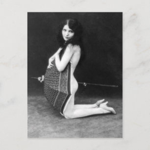 Woman posing with an umbrella - vintage postcard