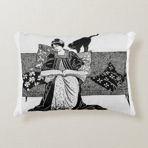 Woman reading with cat accent pillow