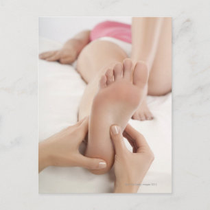 Woman receiving foot massage postcard