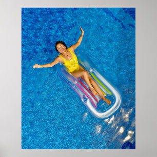 Woman riding on plastic floating buoy on body of w poster