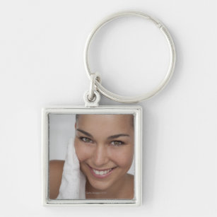 Woman scrubbing her face with cloth keychain