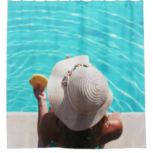 Woman sitting beside swimming pool