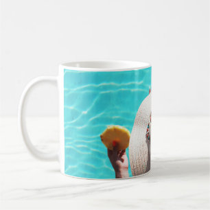 Woman sitting beside swimming pool coffee mug