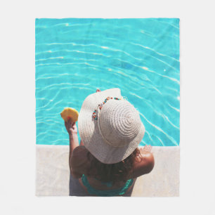 Woman sitting beside swimming pool fleece blanket