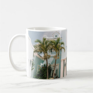Woman sitting in front of building coffee mug