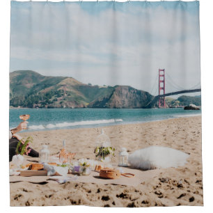 Woman sitting near seashore while looking at Golde
