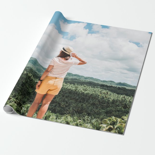 Woman standing near trees wrapping paper (Unrolled)
