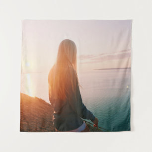 Woman stands near body of water during golden hour tapestry