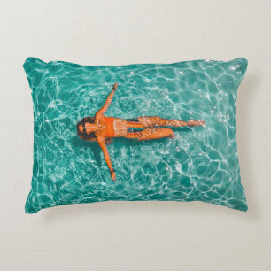 Woman swimming alone in body of water accent pillow