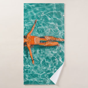 Woman swimming alone in body of water bath towel