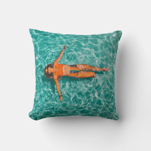 Woman swimming alone in body of water throw pillow