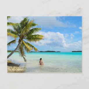 Woman under a palm tree in the Pacific postcard