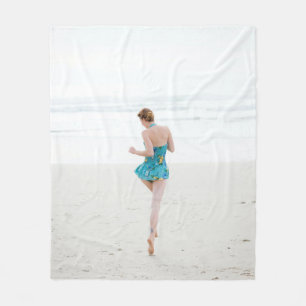 Woman walking on shore near beach fleece blanket