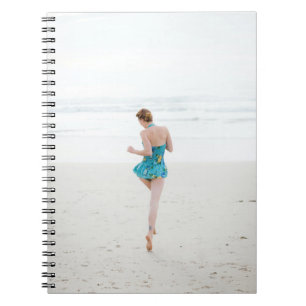 Woman walking on shore near beach notebook