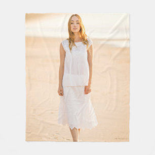 Woman walking on the shore fleece blanket