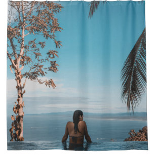 Woman wearing black bikini tap swimming on body of