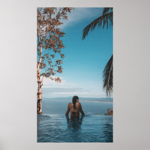 Woman wearing black bikini tap swimming on body of poster