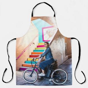 Woman wearing blue denim jacket and shorts riding apron