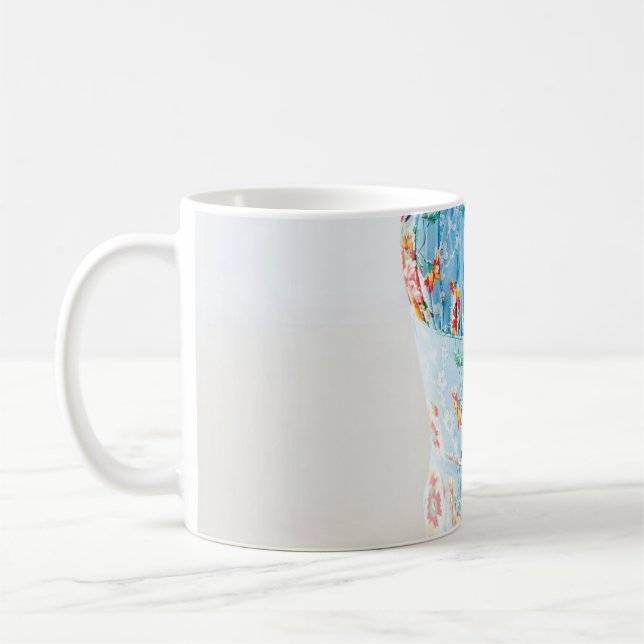 Woman wearing blue floral rompers and brown hat coffee mug (Left)
