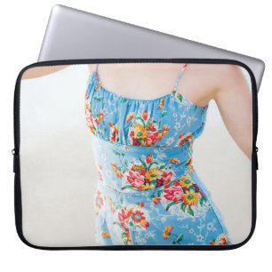Woman wearing blue floral rompers and brown hat laptop sleeve
