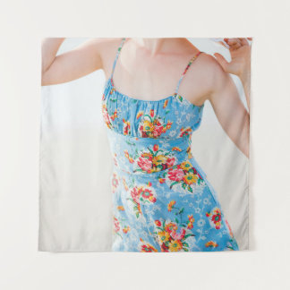 Woman wearing blue floral rompers and brown hat tapestry