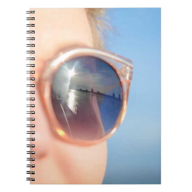 Woman wearing brown framed sunglasses notebook (Front)