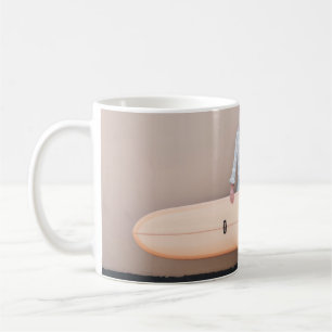Woman wearing grey and white stripe long-sleeved s coffee mug