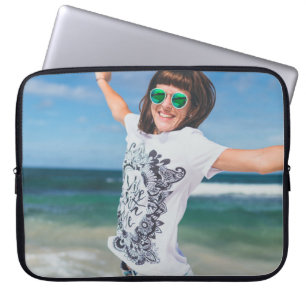 Woman wearing white and black shirt jumping near s laptop sleeve